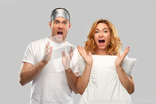 Image of scared couple with eye sleeping mask and pillow