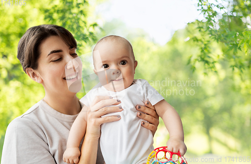 Image of happy young mother holding little baby daughter