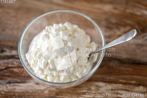 Image of close up of cottage cheese in bowl on wooden table