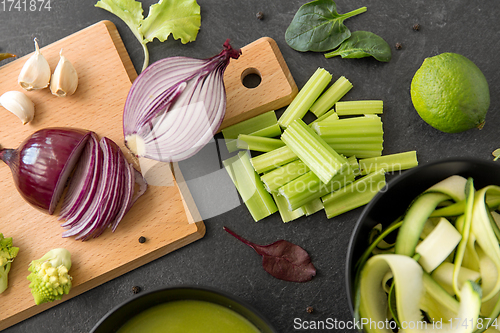 Image of green vegetables and cream soup in ceramic bowl