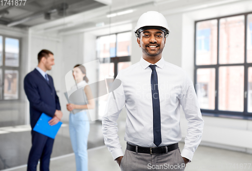 Image of indian male architect in helmet at office room