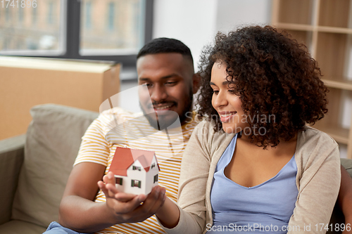 Image of happy couple with house model moving to new home