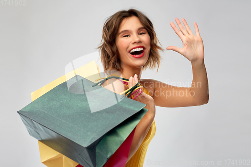 Image of happy smiling young woman with shopping bags