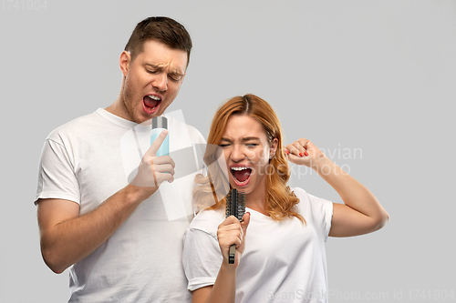 Image of happy couple singing to hairbrush and lotion