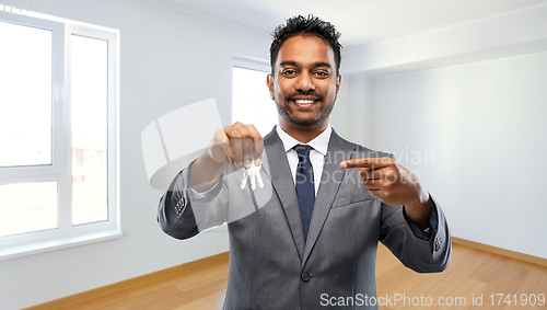 Image of indian man realtor with home keys at new apartment