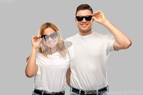 Image of happy couple in white t-shirts and sunglasses