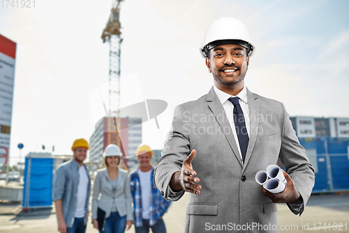 Image of architect making handshake at construction site