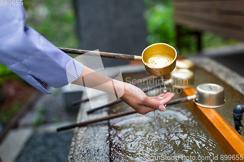 Image of Woman washing hand in japanese temple