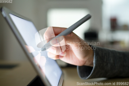 Image of Woman using pen on tablet pc