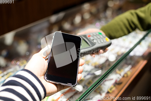 Image of Woman paying with NFC technology