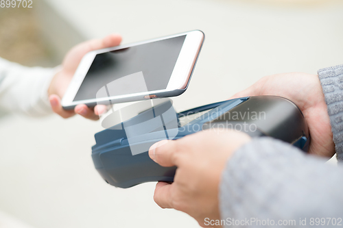 Image of Woman using cellphone for payment