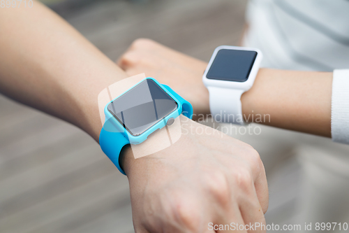 Image of Couple comparing time on smart watch with other