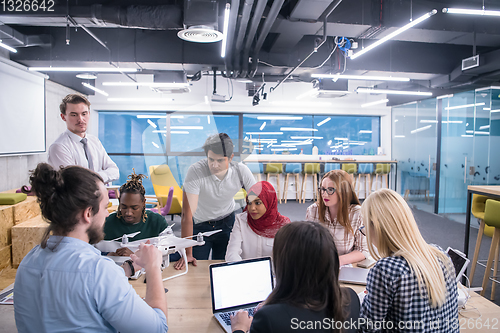 Image of multiethnic business team learning about drone technology