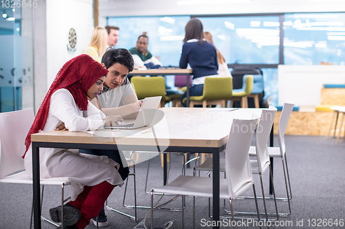 Image of black muslim business woman having a meeting with her indian mal