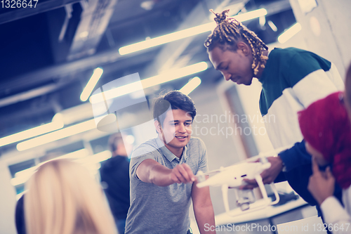 Image of multiethnic business team learning about drone technology