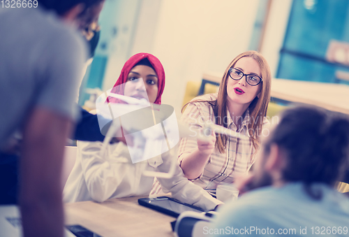 Image of multiethnic business team learning about drone technology