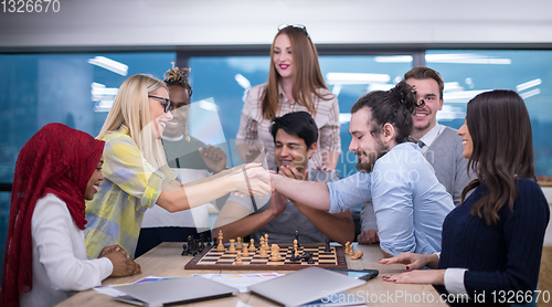 Image of multiethnic group of business people playing chess