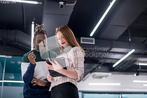 Image of multiethnic business couple using a tablet computer