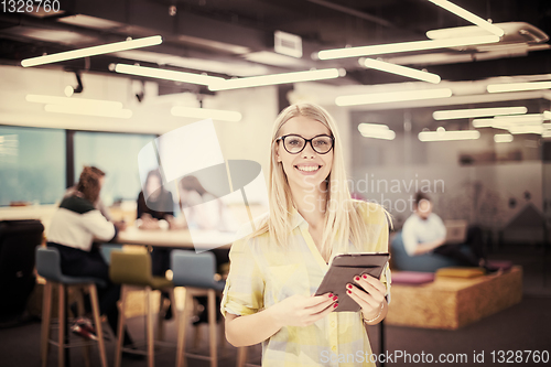 Image of blonde businesswoman working online using digital tablet