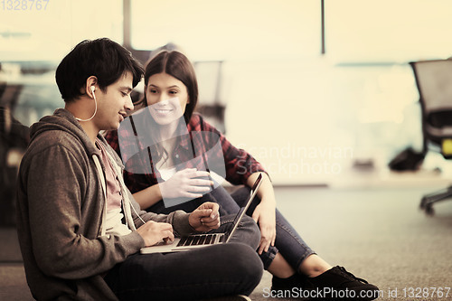 Image of software developers couple working on the floor