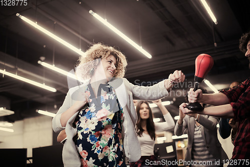 Image of multiethnics business team boxing at office