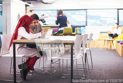 Image of black muslim business woman having a meeting with her indian mal