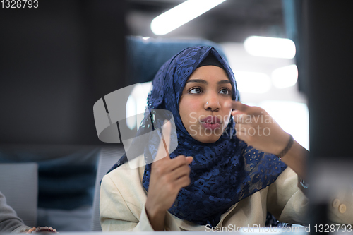 Image of black muslim female software developer at work