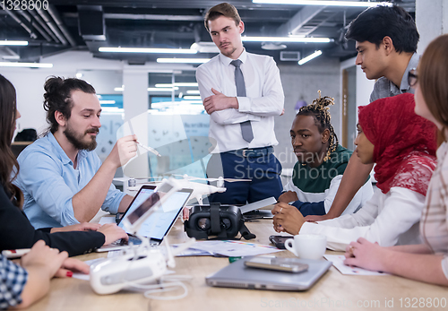 Image of multiethnic business team learning about drone technology