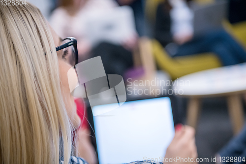 Image of blonde businesswoman using digital tablet