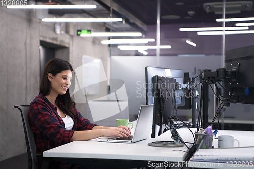 Image of female software developer using laptop computer