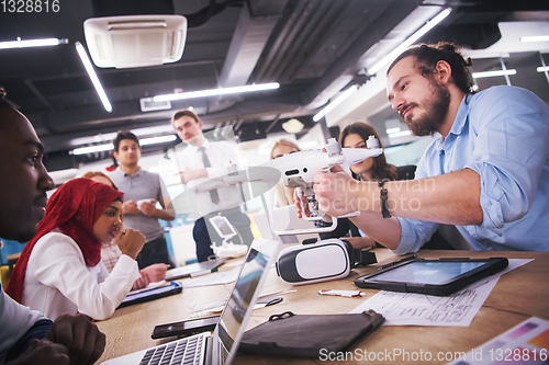 Image of multiethnic business team learning about drone technology