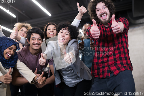 Image of portrait of young excited multiethnics business team