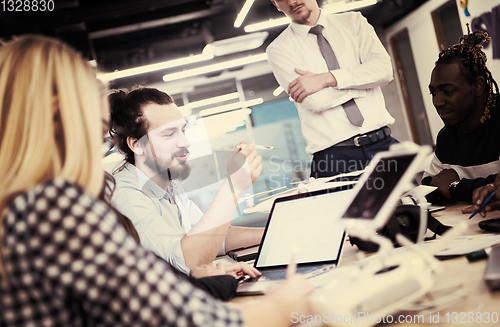 Image of multiethnic business team learning about drone technology