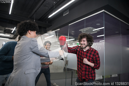 Image of multiethnics business team boxing at office