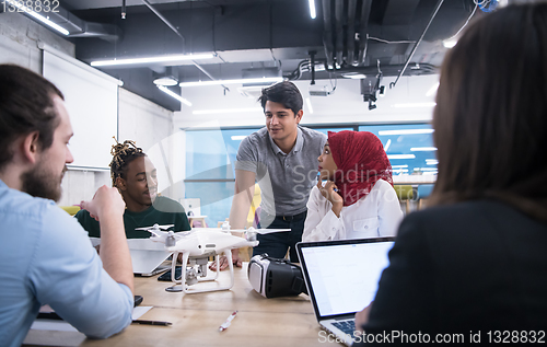 Image of multiethnic business team learning about drone technology