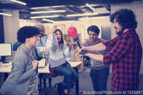 Image of multiethnics business team boxing at office