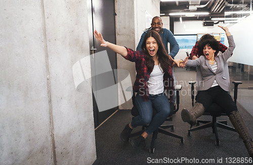 Image of multiethnics business team racing on office chairs