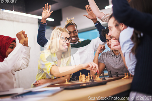 Image of multiethnic group of business people playing chess