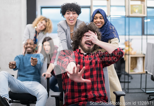 Image of multiethnics business team racing on office chairs