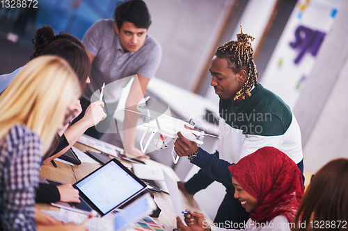 Image of multiethnic business team learning about drone technology