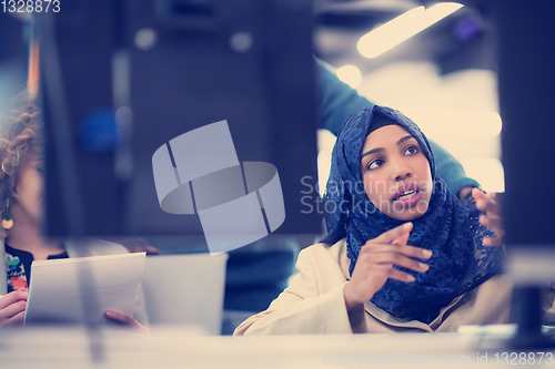 Image of black muslim female software developer at work