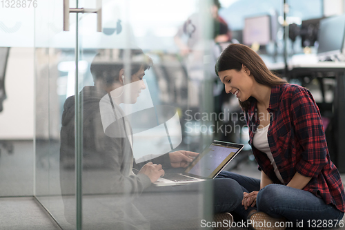 Image of software developers couple working on the floor