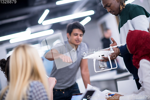 Image of multiethnic business team learning about drone technology