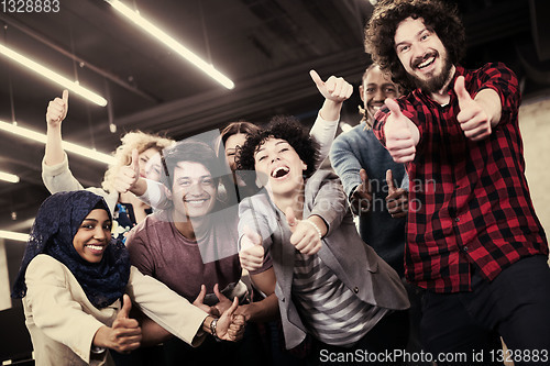 Image of portrait of young excited multiethnics business team