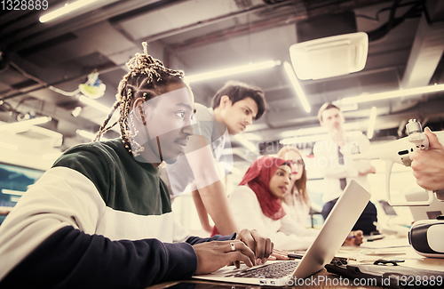 Image of multiethnic business team learning about drone technology