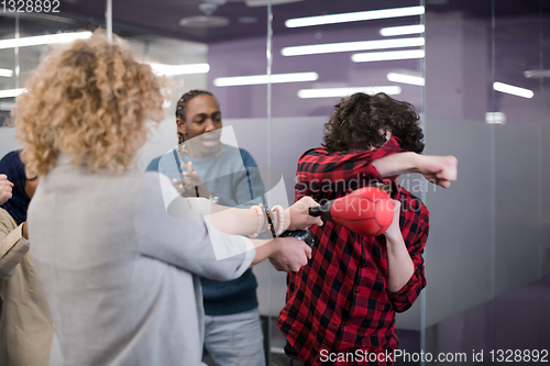 Image of multiethnics business team boxing at office