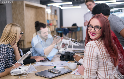 Image of redhead business woman learning about drone technology