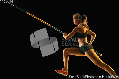 Image of Female pole vaulter training on black studio background in neon light