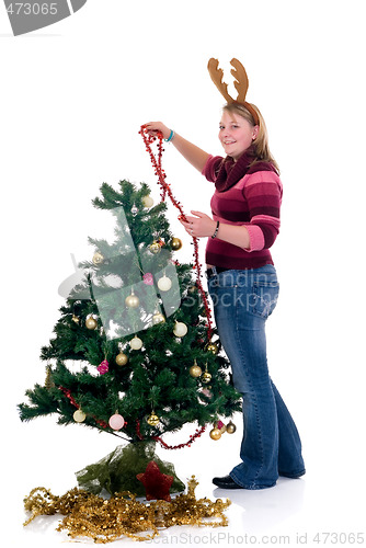 Image of Happy girl decorating Christmas tree
