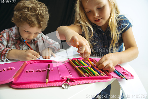 Image of Boy and girl preparing for school after a long summer break. Back to school.